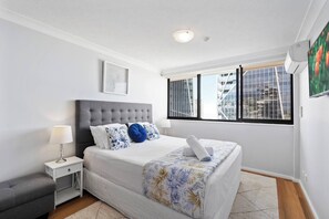 Sleep easy in the plush king-sized bed in the primary bedroom, set with side tables and reading lights.
