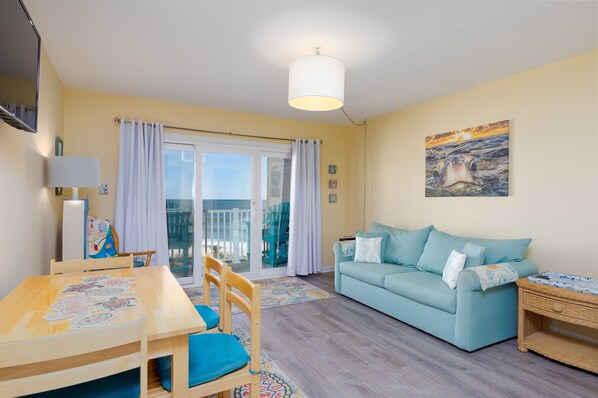 Open-concept living area with dining table and sofa
