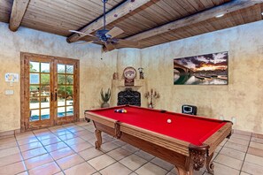 Game of pool in this cozy, rustic game room.