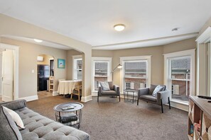 Living area with seating, dining table and extra sofa, large enough to accommodate a smaller adult (under 5'6) or child.