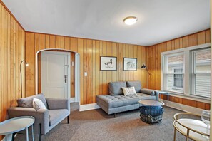 Living area with seating and cozy extra sofa. It's large enough for a small adult or child (under 5'6) to sleep.