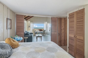 Bright and open bedroom flowing into cozy living space.