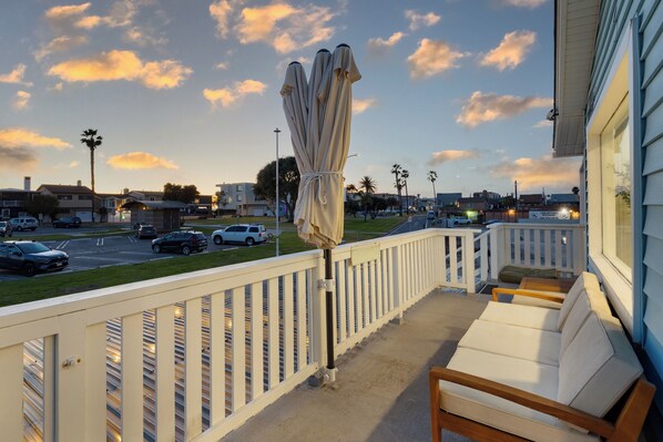 Relax on the balcony as the sun sets, casting a golden glow over the horizon.