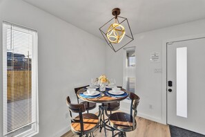 Charming dining table that sits 4 with full tableware and silverware included.