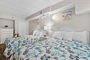 This bright and impeccably clean bedroom is the perfect retreat for a restful night’s sleep, ensuring you wake up refreshed and ready to enjoy every beach day with the family.  2 plush queen beds and plenty of lighting and clothing storage.