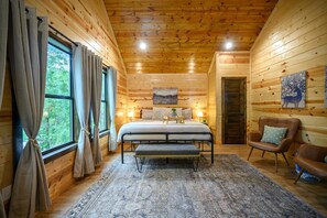 Vaulted ceilings, plush linens, and serene woodland views.
