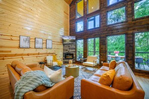 Soaring windows, cozy seating, and nature all around.