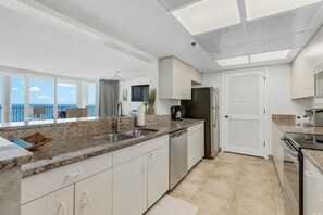The fully equipped kitchen features granite countertops, stainless-steel appliances, and has everything you need to prepare meals for family & friends.