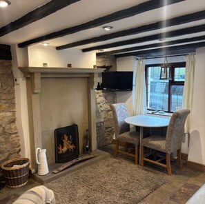Lounge with dining table and open fire