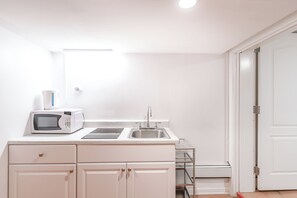 Kitchen with Induction Stove, Microwave, Coffee Maker, Toaster Oven