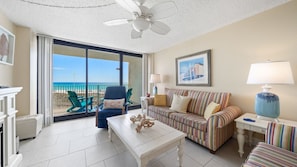 Condo has tile in the living room and a sliding glass door leading to the balcony.