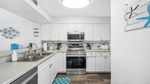 Fully equipped kitchen with stainless steel appliances.