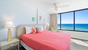 Main bedroom with king size bed and view of the beach and the water.