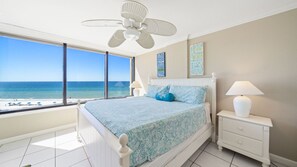 Main bedroom with king size bed and view of the beach and water.