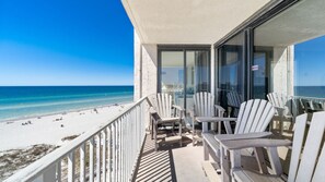 Balcony view of the beach and the water.
