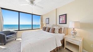 Main bedroom with great views of the beach and water and a king size bed.