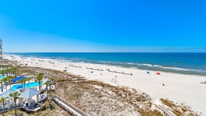 Balcony view of the water and the beach.