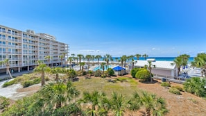 Balcony view of the beach and water.