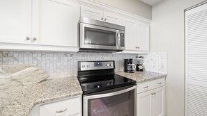Stainless steel stove and microwave.