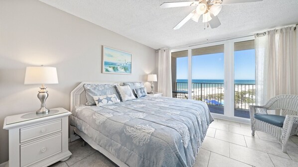 Main bedroom with king size bed and access to balcony.
