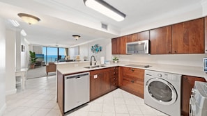 Fully equipped kitchen with stainless steel appliances.
