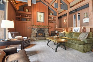 Bright open living space with fireplace, and lush seating
