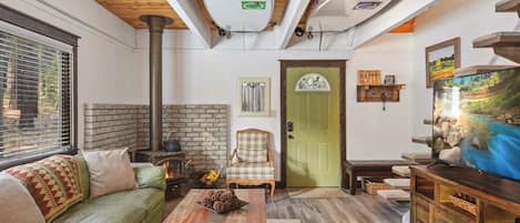 Living room with streaming TV, wood burning fireplace, and comfortable seating