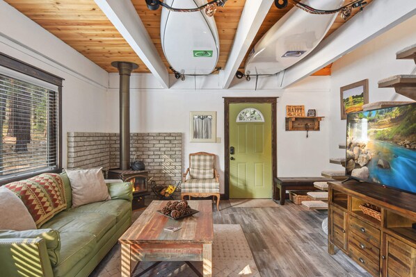 Living room with streaming TV, wood burning fireplace, and comfortable seating