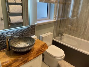 Bathroom with bath and rain shower. Underfloor heating and towel radiator.