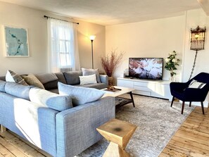 Airy, comfy living room with rustic hardwood floors