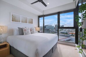 Wake up to stunning city views in the king-sized bedroom, complete with a built-in mirrored wardrobe for ample storage and a ceiling fan for restful nights.