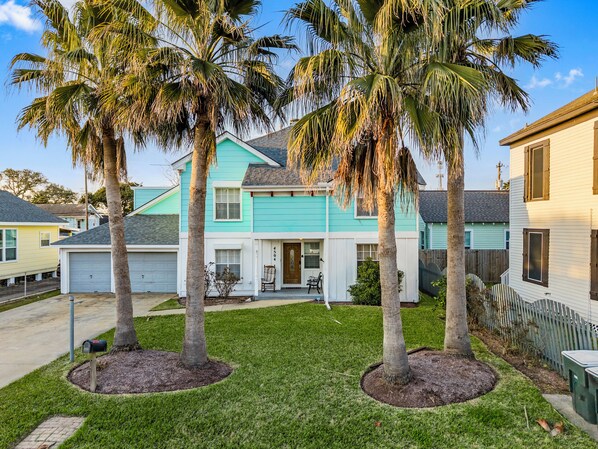 Vibrant palm trees welcome you to a charming retreat just steps from the beach!
