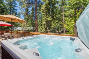 Expansive back deck with gas grill, outdoor dining area & lounge furniture (available during summer) and private hot tub.