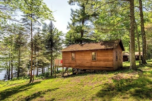 Cabin 3 Exterior - each cabin has a porch with shaded canopy and lake views. 