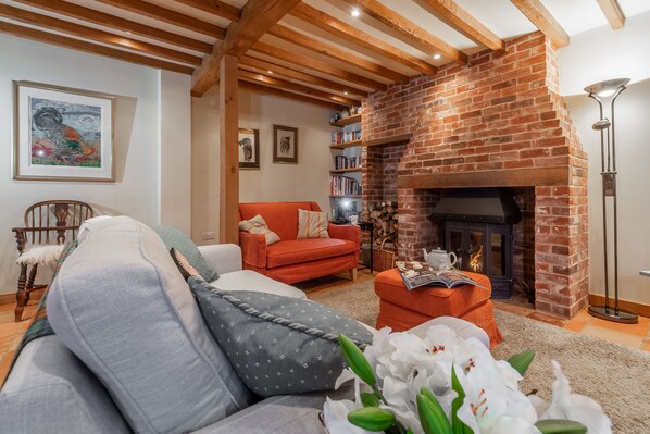The Granary, Hacheston: Cosy sitting room with wood burning stove