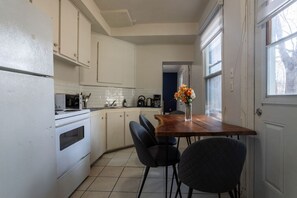 Functional kitchen space with cozy in-kitchen dining setup.