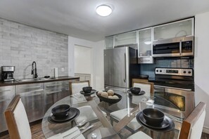Sleek finishes and a thoughtfully designed dining area create a warm and inviting atmosphere