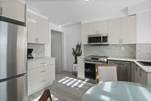 Kitchen – A bright and modern space with sleek cabinetry and stainless steel appliances.