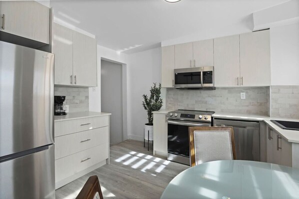 Kitchen – A bright and modern space with sleek cabinetry and stainless steel appliances.