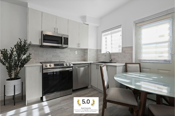 A fresh perspective on the open-concept cooking and dining space, flooded with natural light.