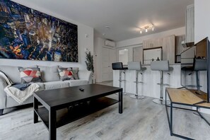 A modern and inviting lounge area that flows seamlessly into the kitchen, perfect for relaxing or entertaining.