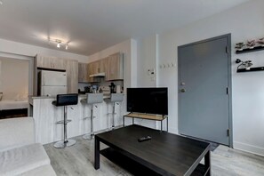Inviting living space with a modern kitchen and bar seating—perfect for relaxing or enjoying a meal.
