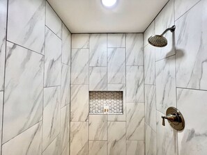 Newly remodeled bathroom with a huge walk-in shower, offering a spa-like experience during your stay
