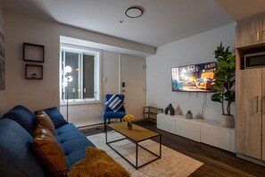 Relax with a movie or your favorite show in this thoughtfully designed living room with ambient lighting.