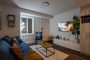 Relax with a movie or your favorite show in this thoughtfully designed living room with ambient lighting.