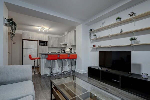 Stylish and modern living space featuring an open-concept layout, a cozy sofa, and a sleek entertainment unit – perfect for unwinding after a long day