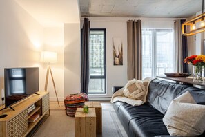 Sunlit living space with balcony access and designer touches.