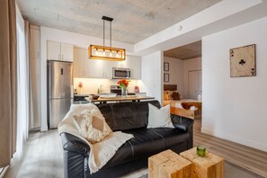 Living Room : Cozy seating and modern kitchen – perfect for relaxing or entertaining.