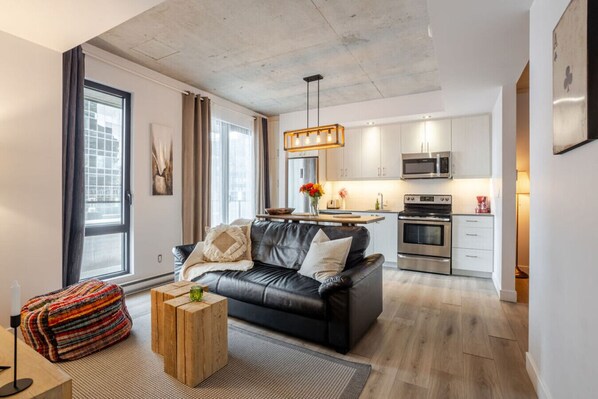 Living room & Kitchen : Bright open-concept living with stylish comfort and full kitchen access.
