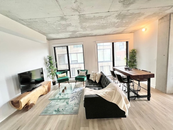 A bright and inviting space with floor-to-ceiling windows, modern decor, and a stylish seating area.